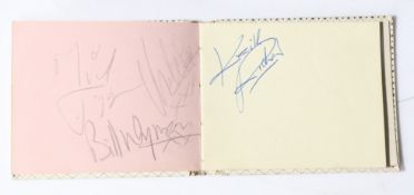 The Rolling Stones. An autograph album containing signatures of The Rolling Stones over three pages.