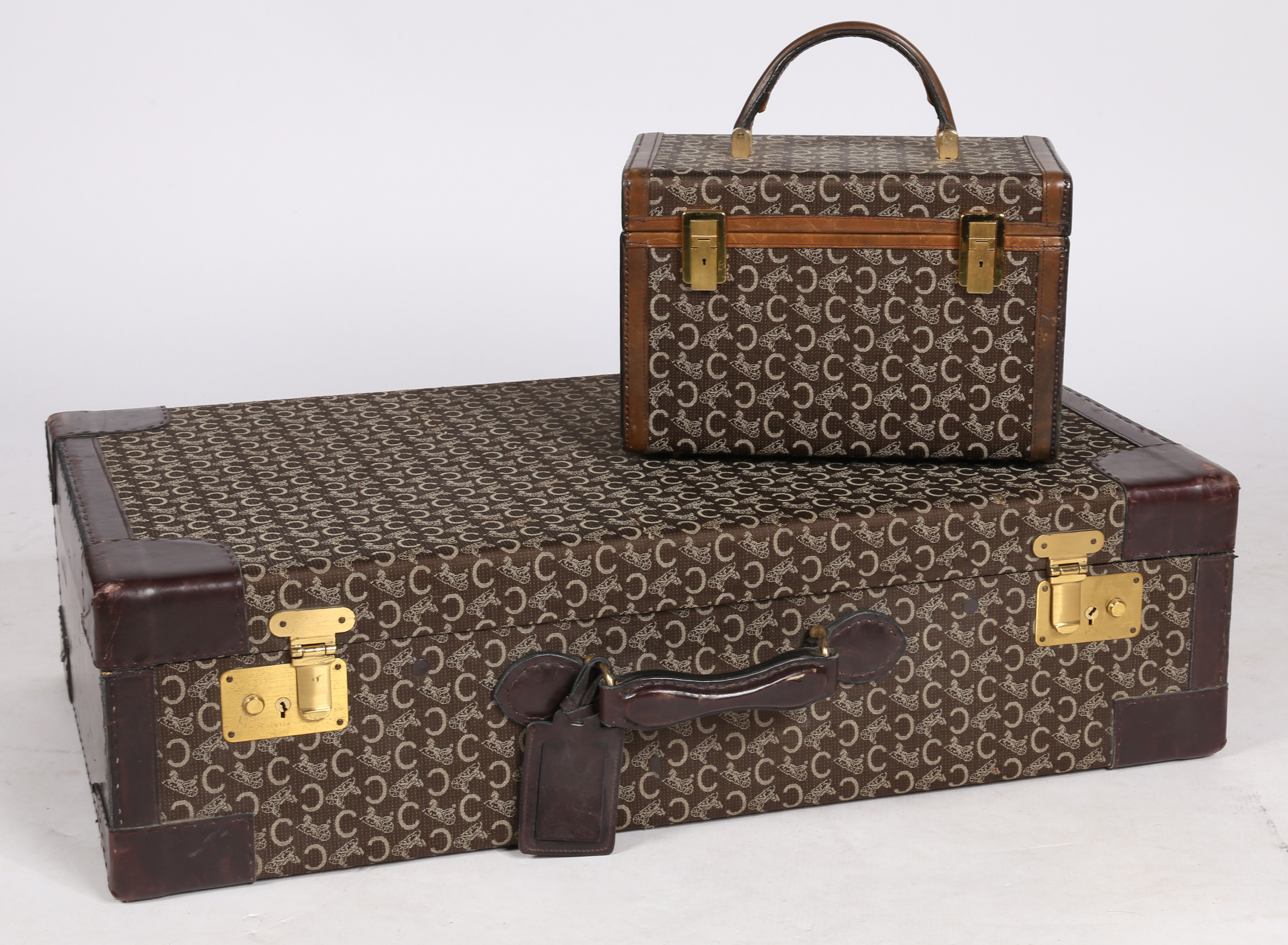 A vintage Celine "C" Macadam pattern, canvas and leather suitcase, together with vanity box.