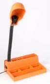 A late 20th Century plastic desk tidy/ reading lamp in orange and black. The adjustable 'goose neck'