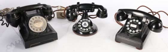 Three vintage Bakelite rotary dial telephones in black. One stamped "BELL SYSTEM MADE BY Western