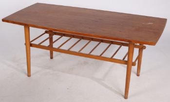 A circa mid 20th Century teak coffee table with magazine rack, 108cm x 52cm x 47cm.