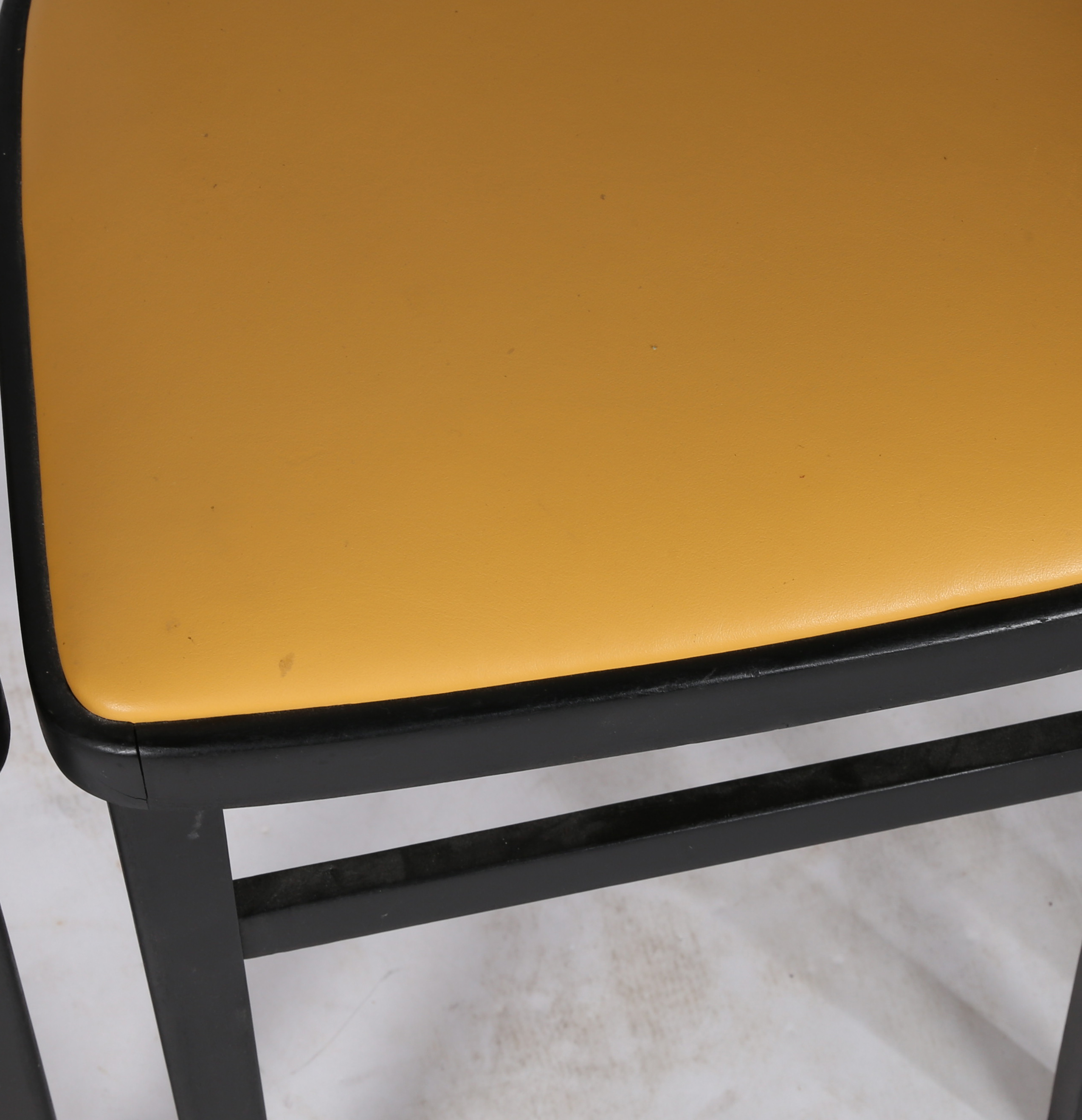 A set of four painted and vinyl upholstered dining chairs in black and tan, stamped to the underside - Image 3 of 4