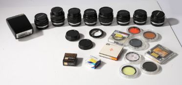 A large collection of Olympus Zuiko lenses. To include a Zuiko Shift 1:2.8 f=35mm. This lot also