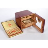 A cigar humidor, with front hygrometer. Contents include (9x Hamlet Special Panatellas, 3x King