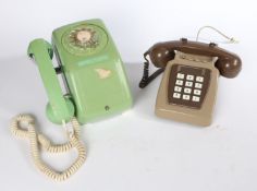 Two retro circa 1970s telephones. To include a green and chromed, rotary dial, wall hanging
