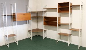 A mid 20th Century teak Ladderax corner modular system on white steel supports, to include various