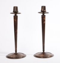A pair of circa 1930s Bakelite candlesticks of tapering form, raised on round bases, marked to the