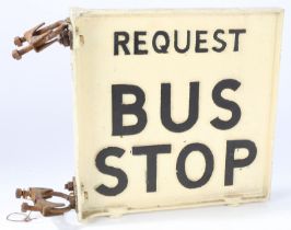 A painted metal bus stop sign "Request Bus Stop". The black lettering on a cream background, 31cm