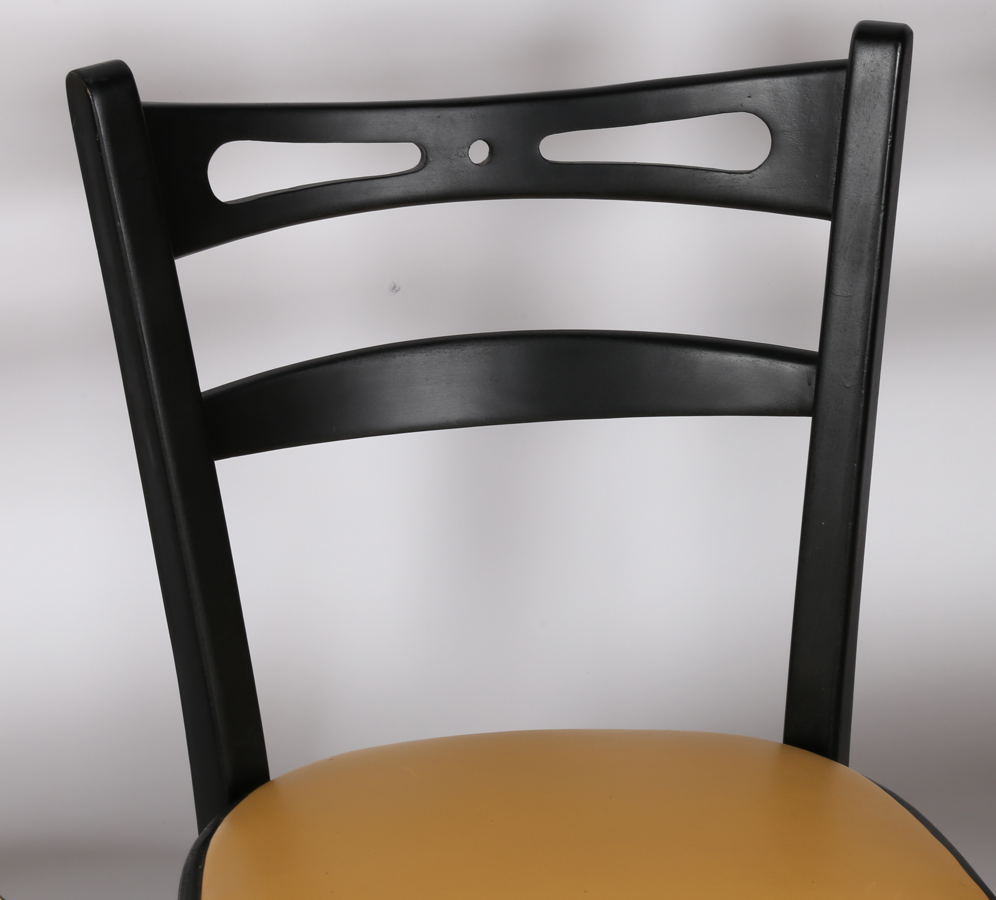 A set of four painted and vinyl upholstered dining chairs in black and tan, stamped to the underside - Image 4 of 4