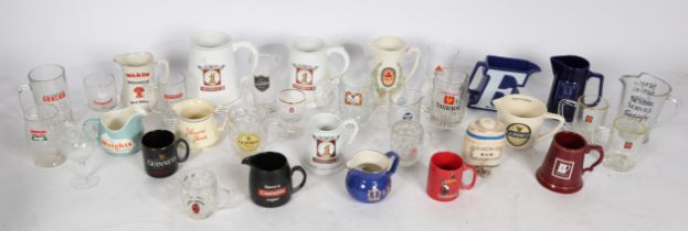 A collection of often brewery related advertising glasses, jugs and mugs of various sizes, brands to