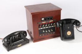 Two unmarked American Bakelite telephones, one AF. Together with a vintage telephone switchboard,