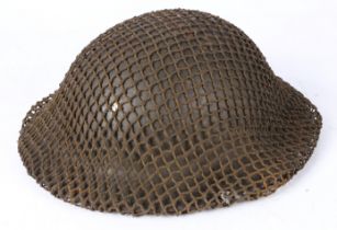 Second World War British MK II Steel Helmet, complete with liner, chin strap and camouflage helmet