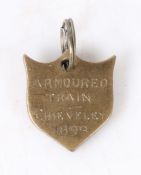 Boer War souvenir fob in the form of a shield, in brass, engraved 'ARMOURED TRAIN, CHIEVELEY, 1899',