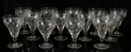 A matched group of thirteen glass rummers, with etched fruiting vine decoration above knopped