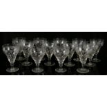 A matched group of thirteen glass rummers, with etched fruiting vine decoration above knopped