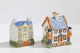 Two 19th century Pratt Ware polychrome money boxes/banks, each in the form of houses, one with two