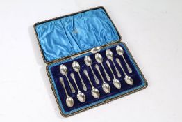 Thirteen George V silver teaspoons, Sheffield 1933, maker Walker & Hall, with crossed golf club