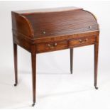 A George III mahogany and boxwood inlaid cylinder bureau, the tambour top enclosing a fitted