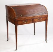 A George III mahogany and boxwood inlaid cylinder bureau, the tambour top enclosing a fitted
