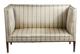 An Edwardian mahogany high back two seater canape, with striped upholstery and raised on square legs