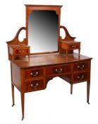An Edwardian mahogany, satinwood and boxwood strung dressing table, the shaped bevelled mirror