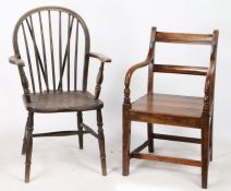 A 19th Century ladder back armchair, with arched and turned arms, solid seat, on square tapering
