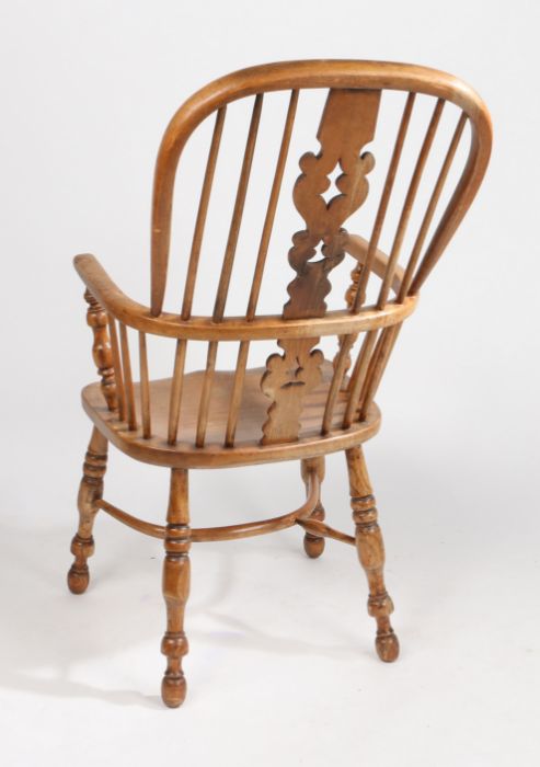 An 18th Century ash and elm elbow chair, probably East Anglian, the arched back with turned spindles - Image 2 of 2