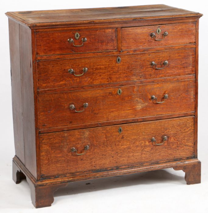 A George III mahogany chest of two short and three long drawers, with brass swan neck handles,