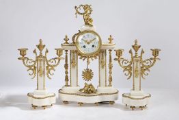 A French white marble and gilt brass three piece clock garniture, the dial surmounted with putti,