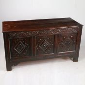 A late 17th Century carved oak triple panel coffer, the twin plank top, above a acanthus leaf and