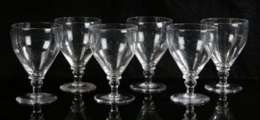 A set of six 19th Century glass rummers, the plain tapering bowls above bulbous knopped stems and