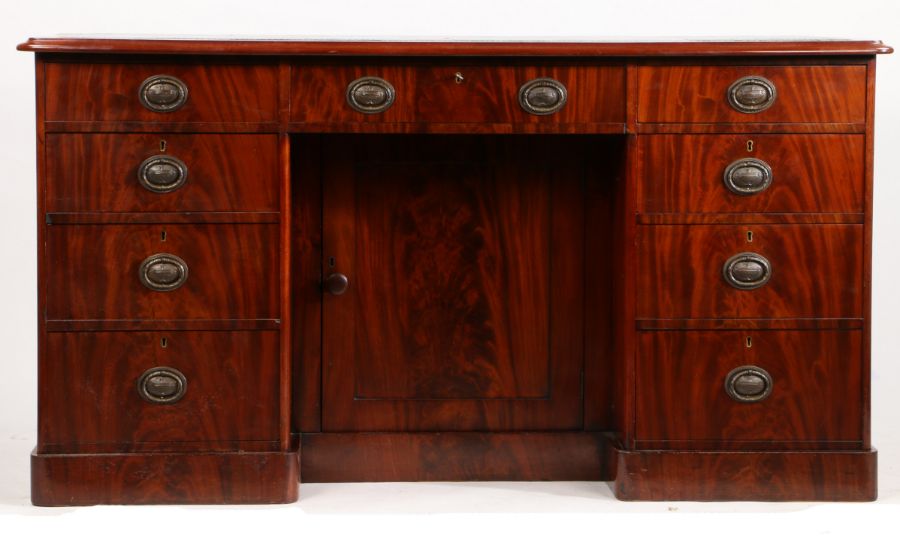 A Victorian mahogany desk, the tooled green leather inset top above three frieze drawers, three