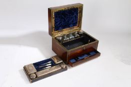 A Victorian rosewood and brass bound vanity box, the hinged lid enclosing a plush lined interior,