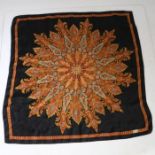 A Liberty of London silk scarf, orange and turquoise design on a black ground, 68cm square