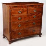 A George III mahogany and boxwood strung chest of drawers, with two concealed drawers to the