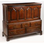 A mid 18th Century Welsh ash and elm mule chest, the hinged lid above four fielded panels flanked by