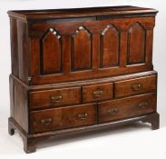 A mid 18th Century Welsh ash and elm mule chest, the hinged lid above four fielded panels flanked by