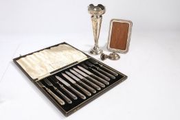 A set of six silver handled fruit knives and forks, housed in a fitted case, a silver spill vase