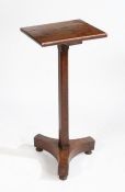 A 19th Century oak occasional table, the rectangular top raised on a square chamfered stem, tripod