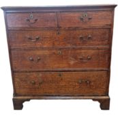 A George III oak chest of two short and three long drawers, with brass swan neck handles, raised