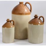 Three stoneware flagons, to include a six gallon example (3)