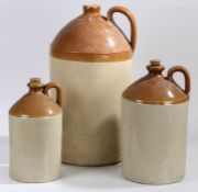 Three stoneware flagons, to include a six gallon example (3)