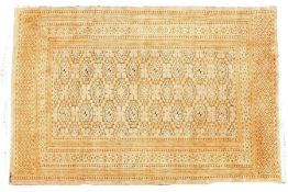 An unusual Persian rug, the golden ground set with multiple guls and multiple repeating borders,