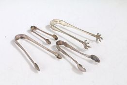 Four pairs of George III and later silver sugar tongs, various dates and makers, to include a pair