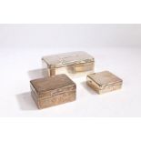 Three silver cigarette boxes, the largest with inscribed lid "DANCING GIRL LANCASTER 1908", one with