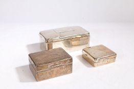 Three silver cigarette boxes, the largest with inscribed lid "DANCING GIRL LANCASTER 1908", one with