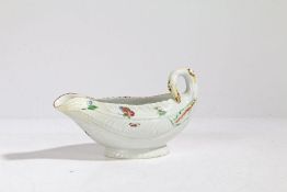 An 18th century Derby porcelain sauce boat, painted with butterflies and flowers, 18cm wide