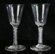 A pair of 18th Century air twist glasses, the slice decorated tapering bowls above spiralling air-
