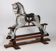 A 20th Century rocking horse, the dappled grey horse with horse hair mane and tail, the frame with