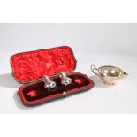 A pair of Victorian silver pepperettes, London 1898, maker Joseph Walton, with domed tops and